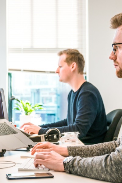 two men working on laptop