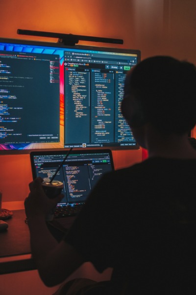 programmer sitting in front of screens